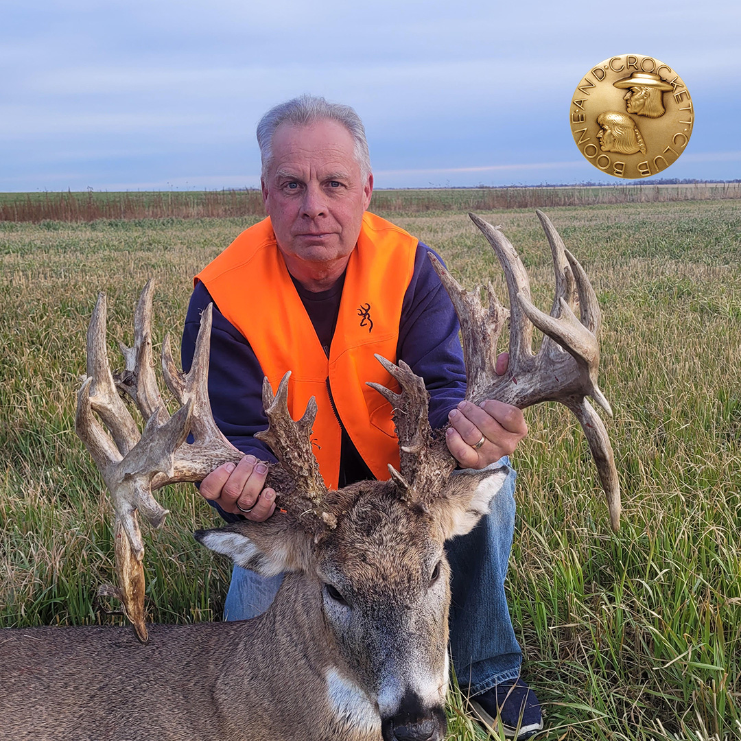 man with whitetail deer