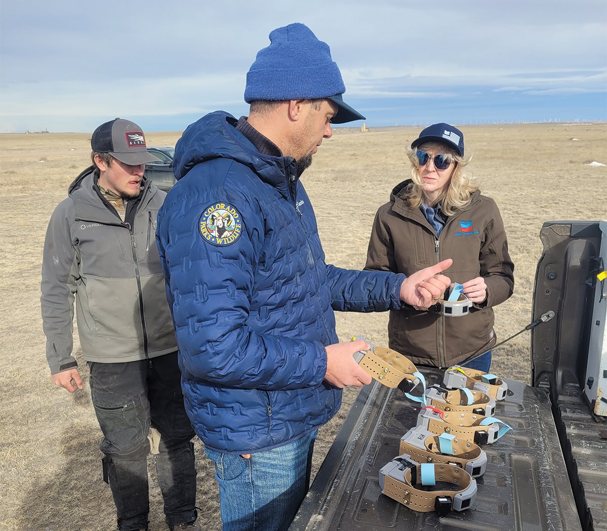 Joe Halseth (center) and Patricia Minerich (right) reviewing the GPS collars