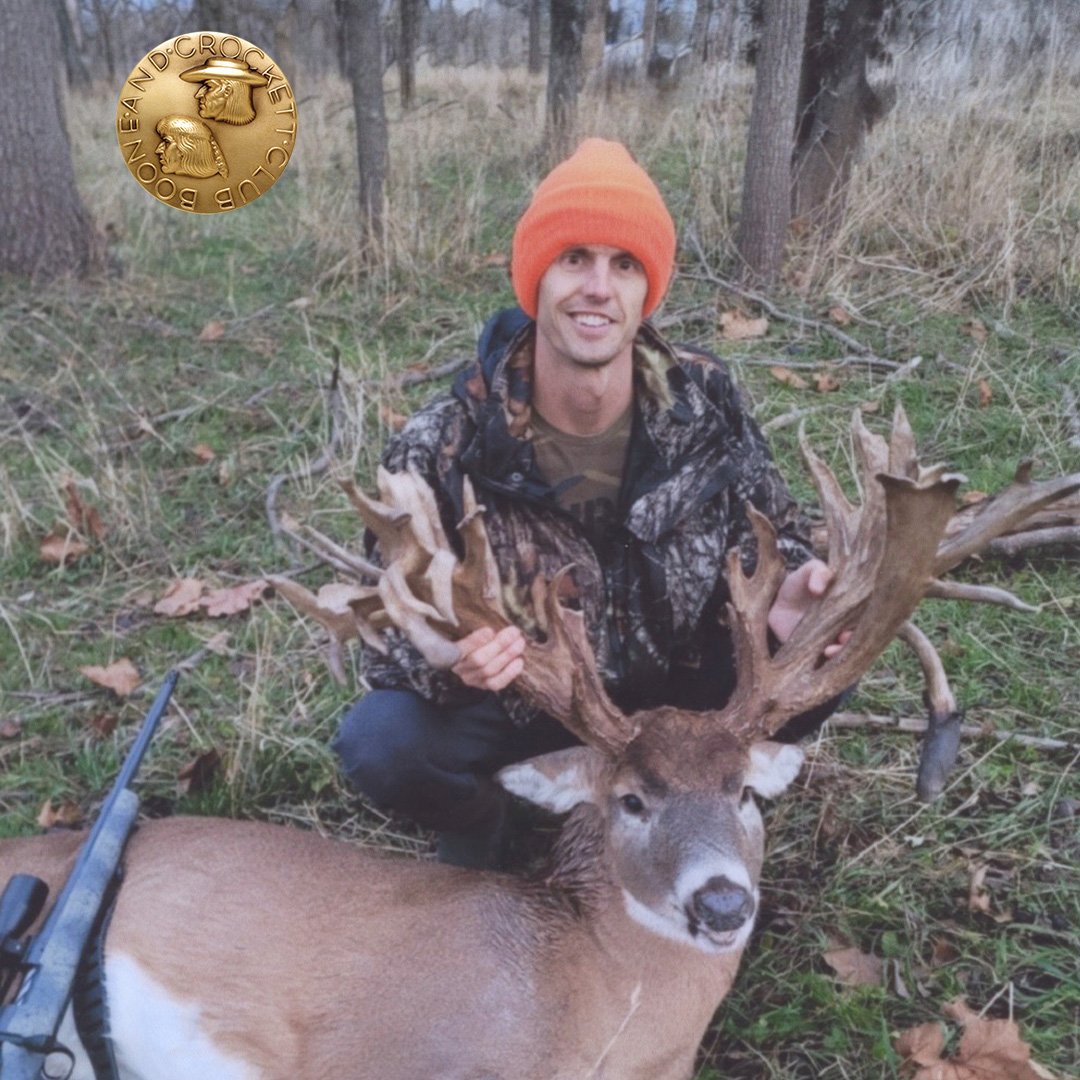 man with whitetail deer