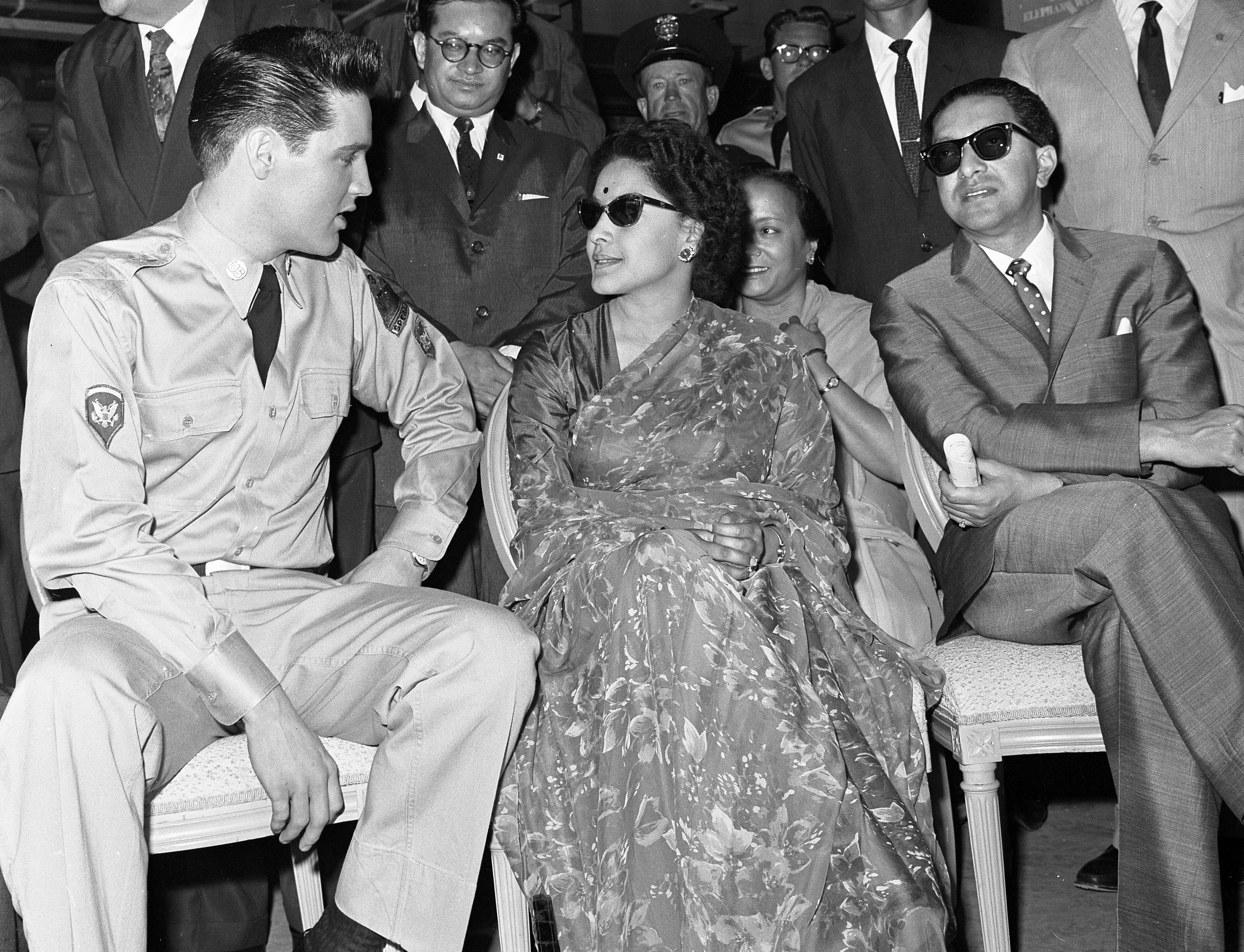 The king of rock & roll meets with King Mahendra (far right) and Queen Ratna while on the set of "G.I. Blues."