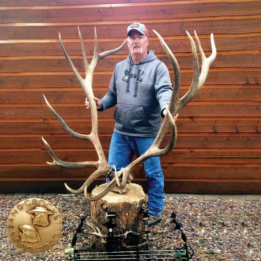 man with elk shed