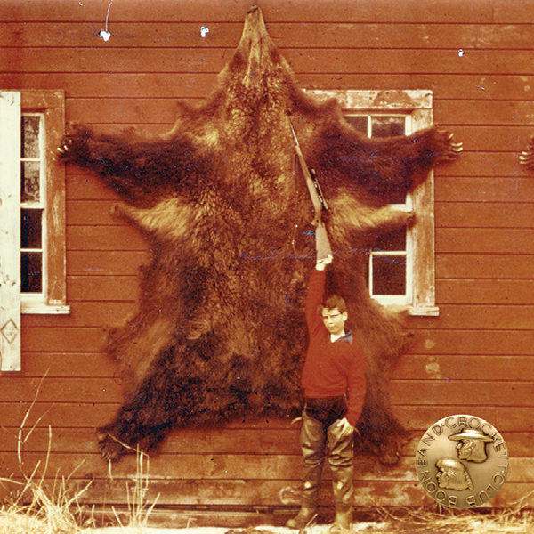 vintage photo of a man with a grizzly bear