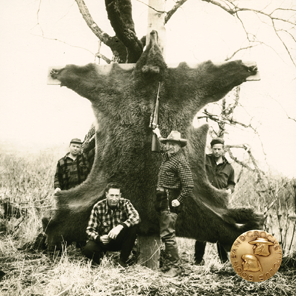 vintage photo of a group of men with a grizzly bear