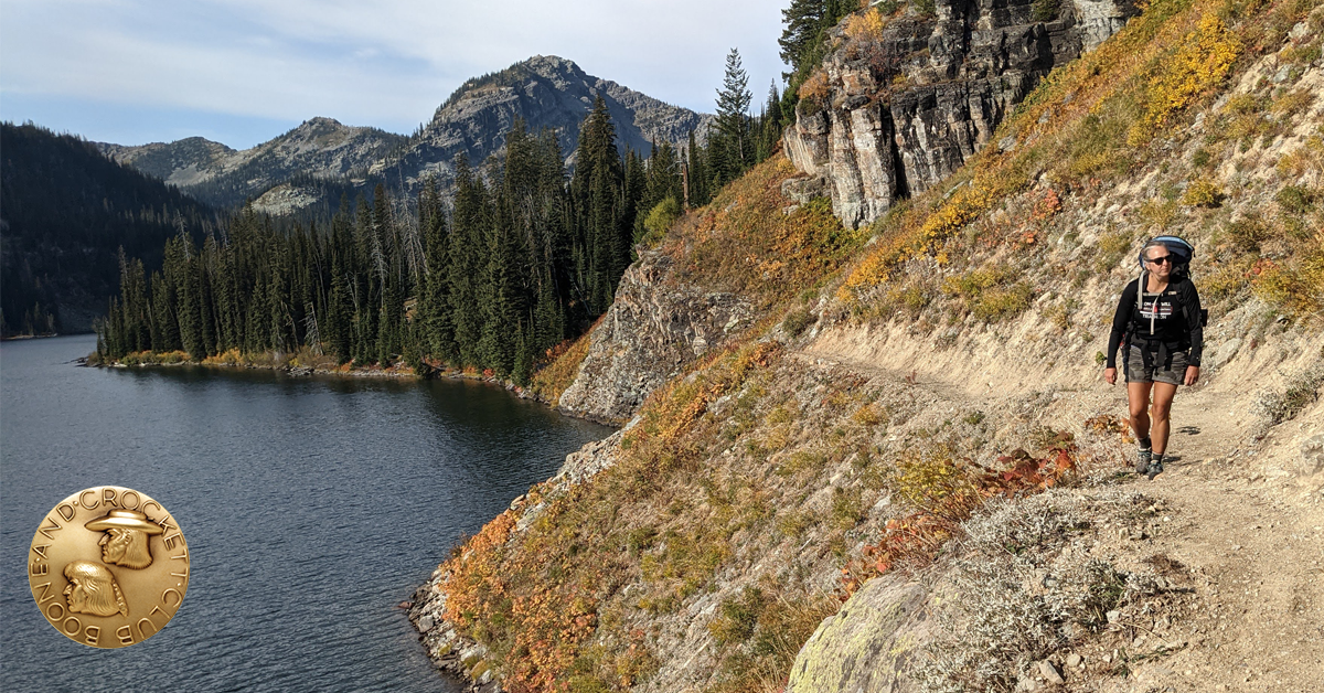 Woman hiking by lake