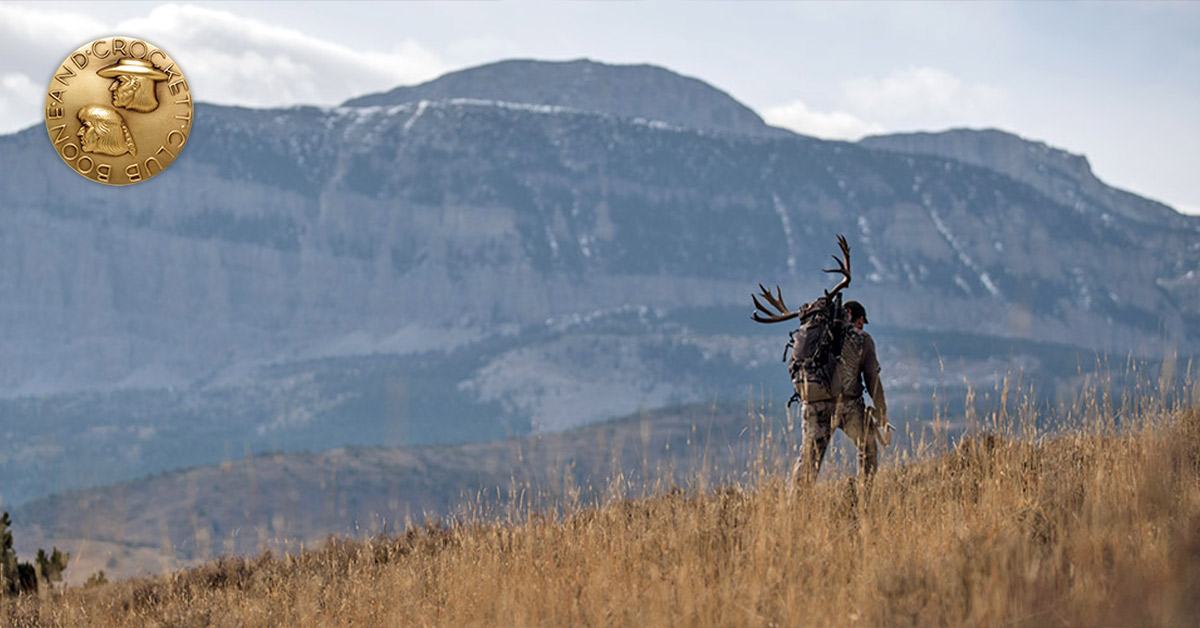 man packing out animal
