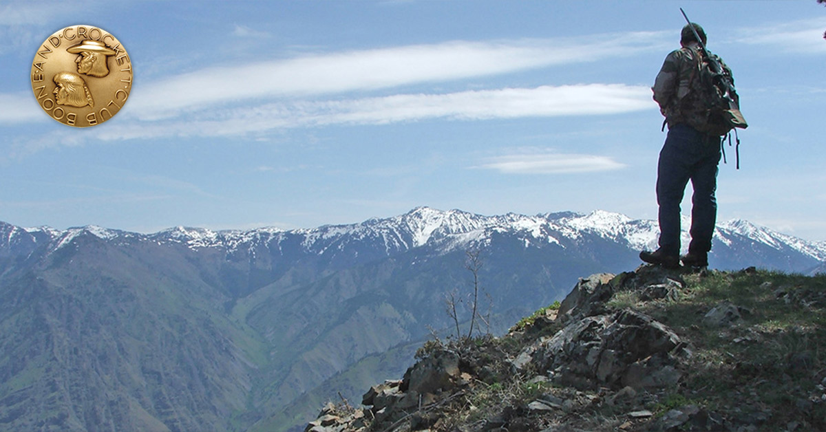 hunter on mountain top