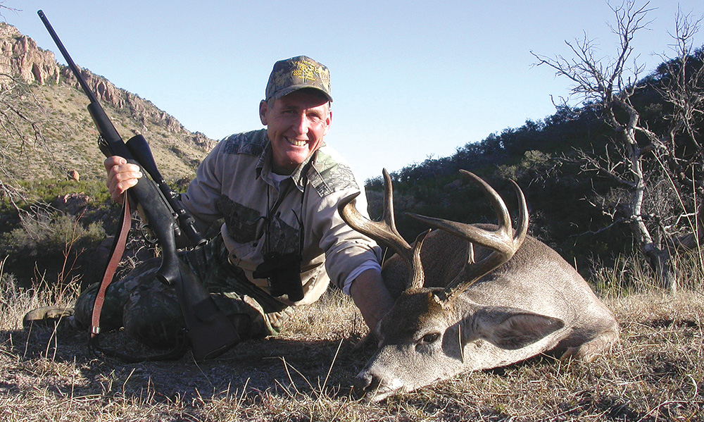 hunter with coues' whitetail deer