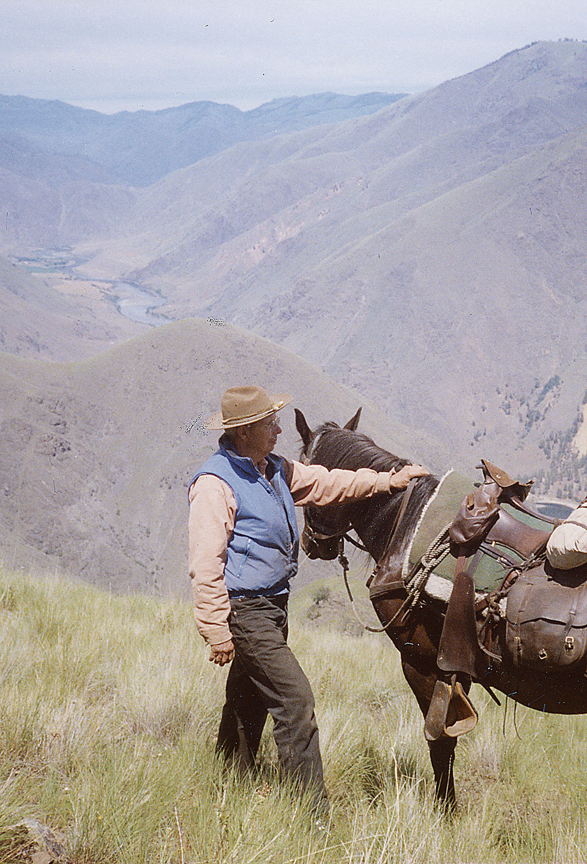 man and his horse in the mountains