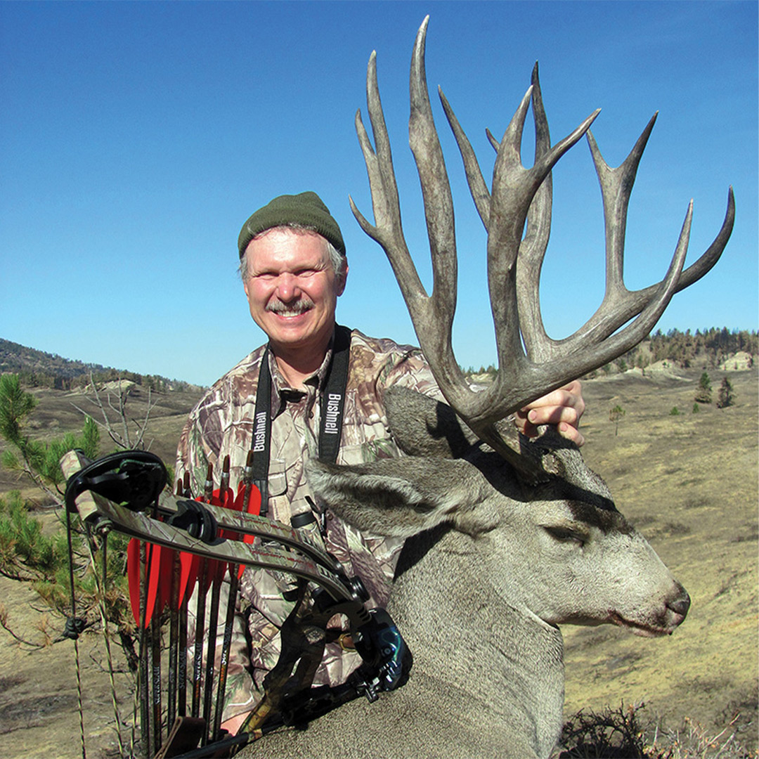 hunter with mule deer