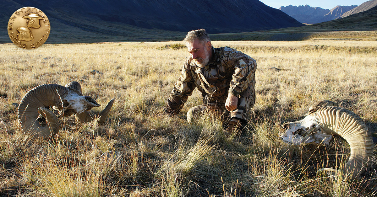 hunter with two sheep skulls