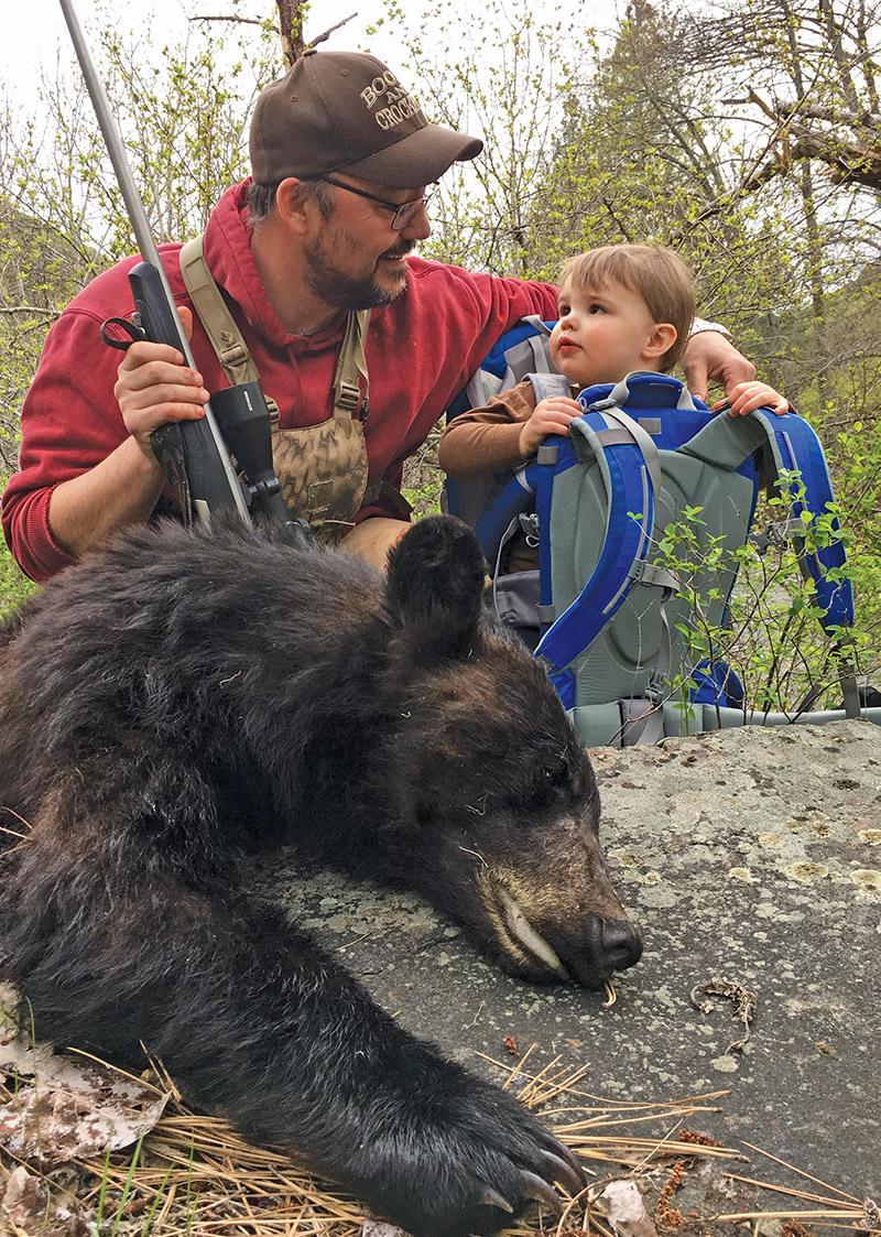 father and son with black bear harvest
