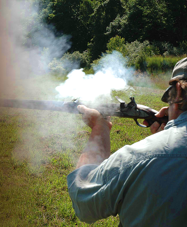 man shooting old rifle