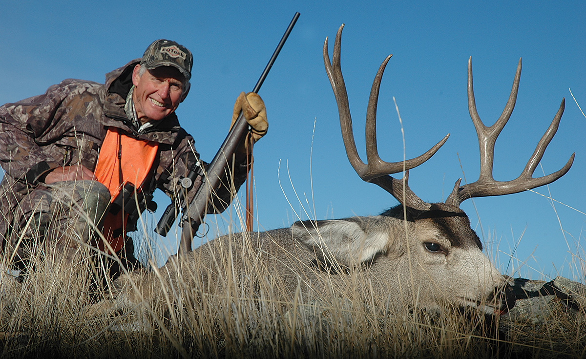 hunter with mule deer