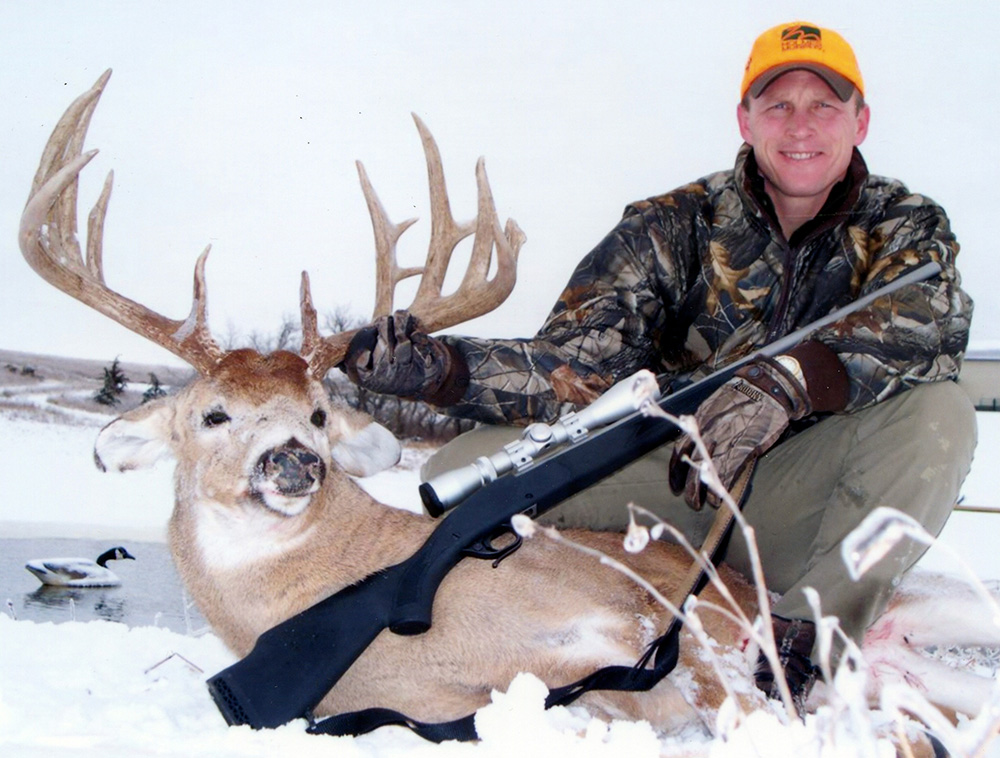hunter with whitetail deer