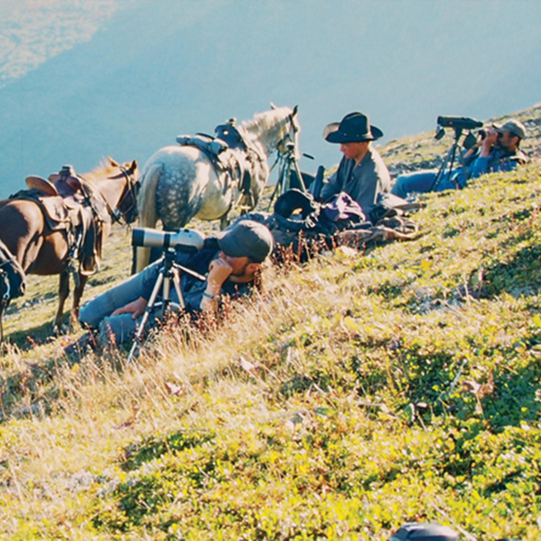guys shooting photography on side on mountain