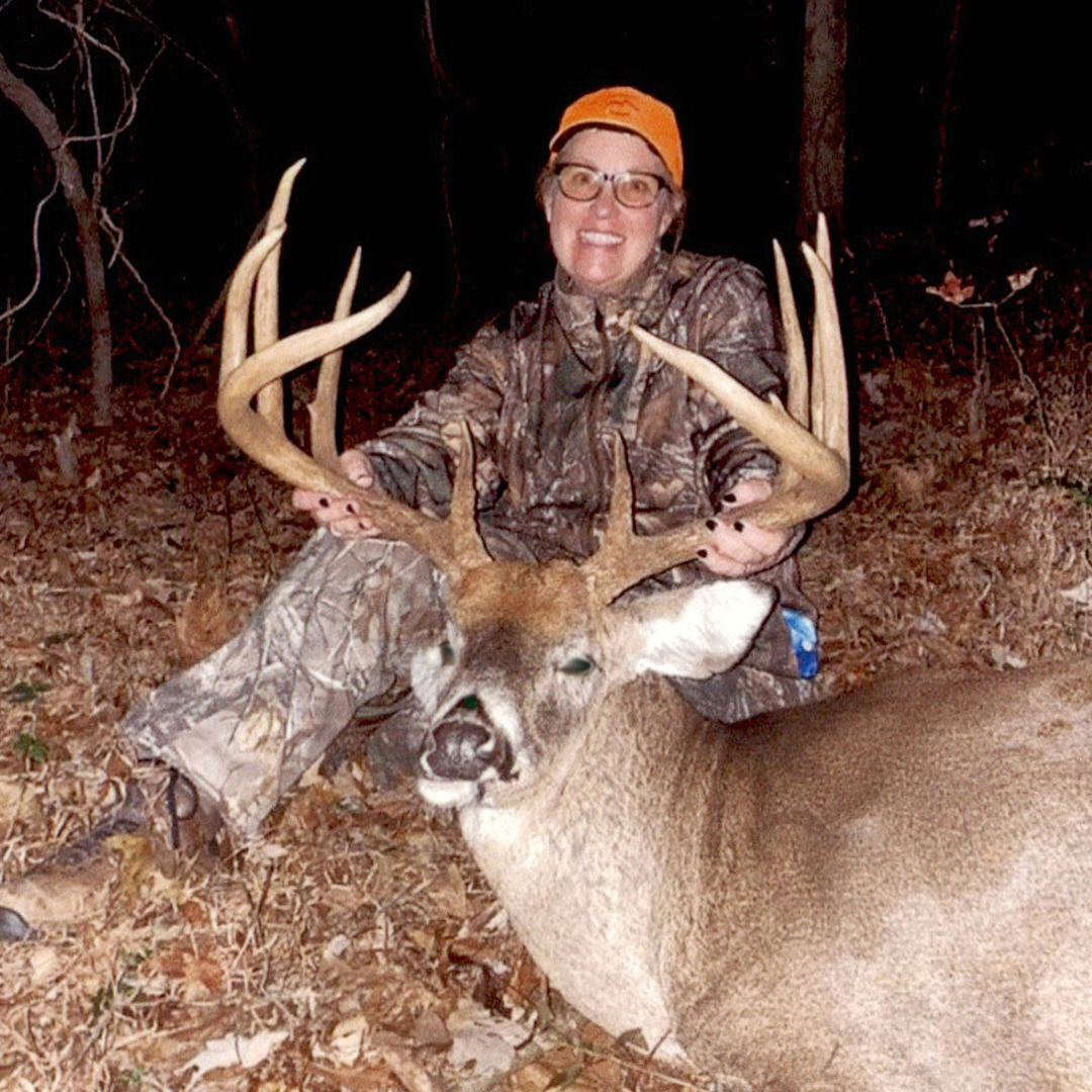 female hunter with whitetail deer trophy