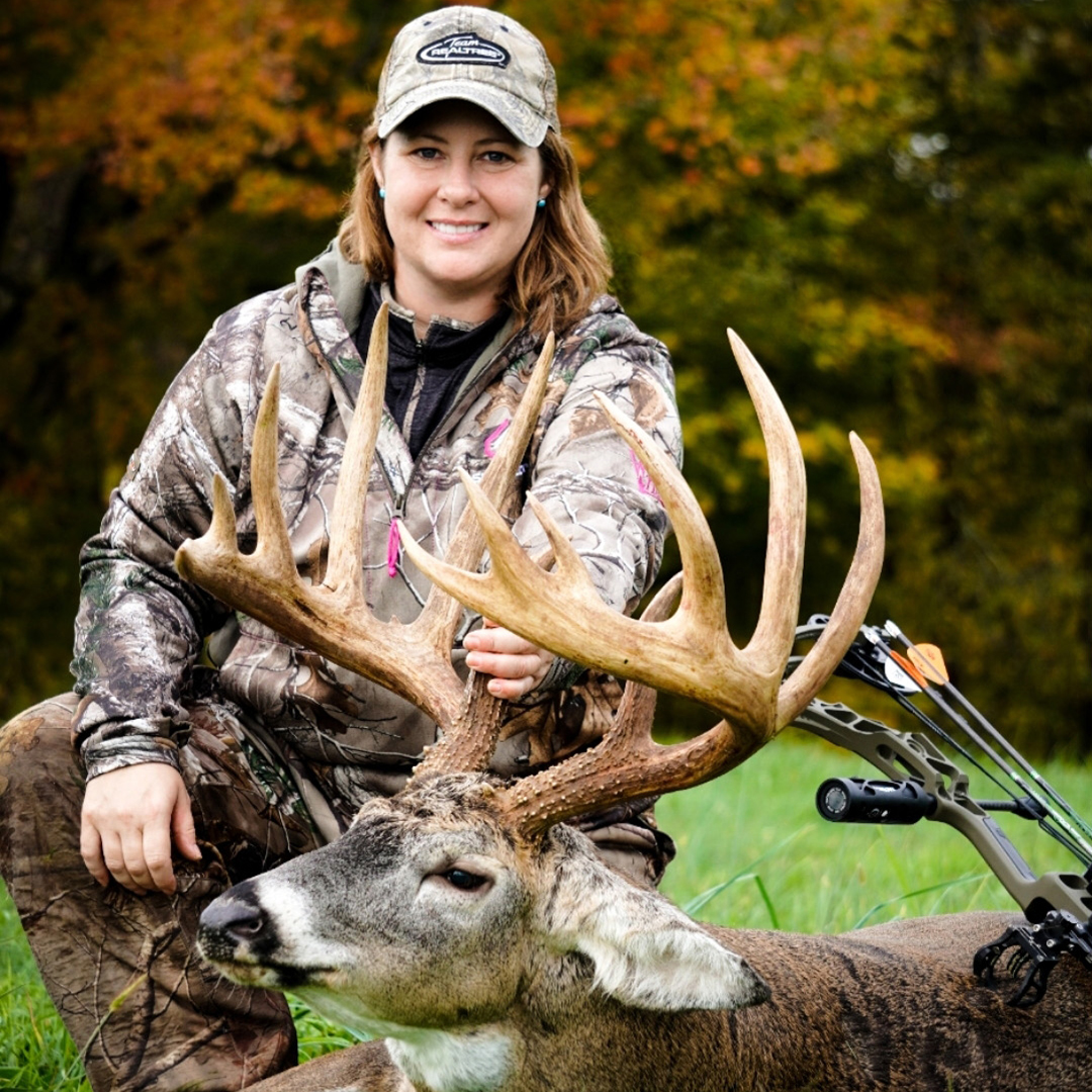 female hunter with whitetail deer