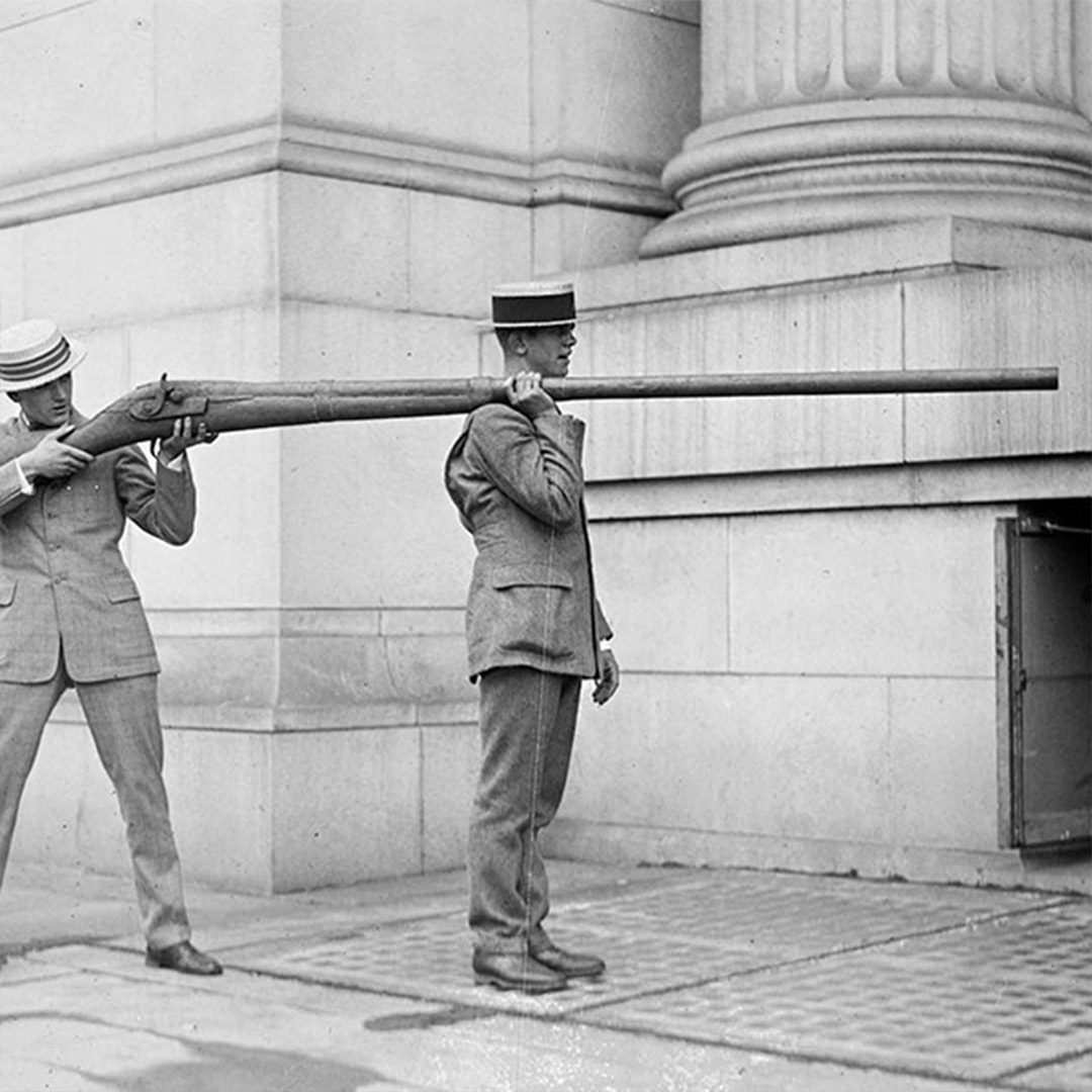two men holding giant rifle