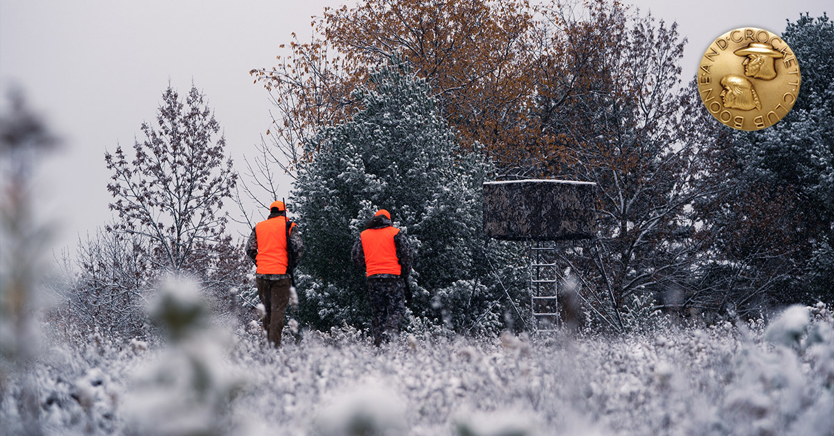 two hunters walking to stand
